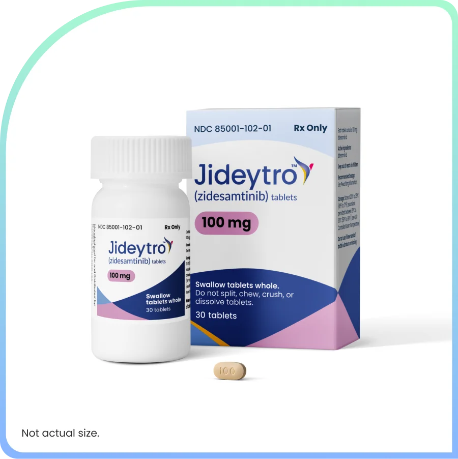Jideytro (zidesamtinib) 100 mg tablets shown in a prescription bottle and carton, with one tablet in front